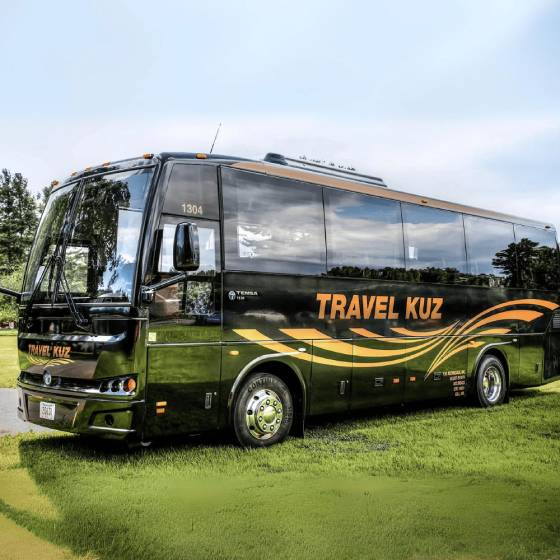 Soccer fans from Western Massachusetts and Vermont traveling together by charter bus to Gillette Stadium for a 2026 FIFA World Cup match with teams like England, France, and Norway, organized by TravelKuz